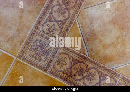beautiful light brown ceramic tile with patterns on the floor. Stock Photo