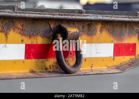 Close up of a rusty metal ring attached to the side of an old and dirty platform Stock Photo