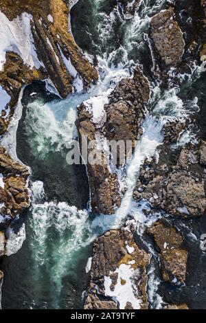 Aerial view of Godafoss waterfall, snowy shore and river. Iceland in early spring Stock Photo