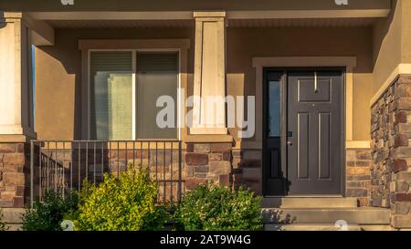 Panorama frame Stairs leading to porch and front door with sidelight at the entrance of home Stock Photo