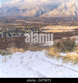 Photo Square frame Snow covered Mount Timpanogos towering over neighborhood houses in the valley Stock Photo