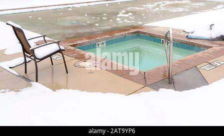 Panorama frame Childrens pool and frozen adult swimming pool surrounded by snow in winter Stock Photo