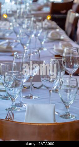 Photo Vertical Tableware arranged on round table with white cloth for eating at an occasion Stock Photo