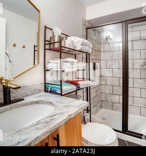 Square Bathroom interior with black and white tile wall and marble countertop Stock Photo