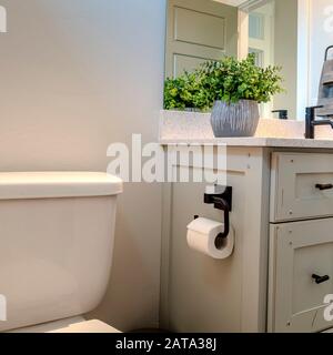 https://l450v.alamy.com/450v/2ata38j/square-vanity-cabinet-and-toilet-inside-the-bathroom-of-home-with-white-wall-2ata38j.jpg