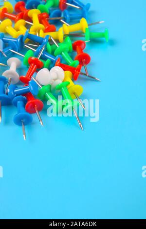 Metal push pins on Blue background Stock Photo