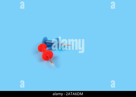 Metal push pins on Blue background Stock Photo