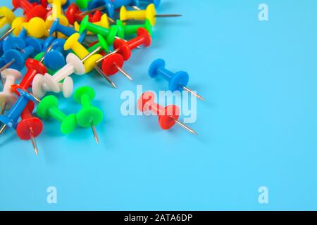 Metal push pins on Blue background Stock Photo