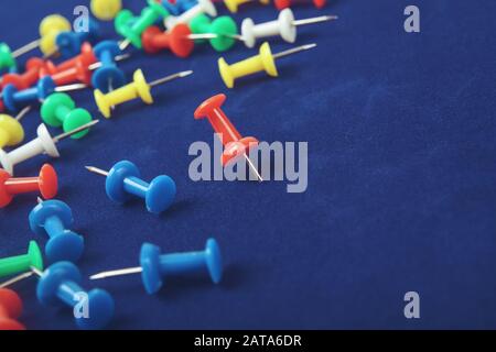 Metal push pins on Blue background Stock Photo