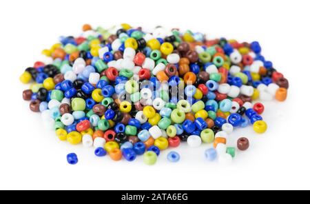 Heap of multi-colored beads for needlework isolated on a white background Stock Photo