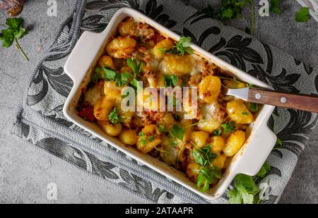 Super fast and delicious food, gratinated gnocchi with minced meat, tomatoes and cheese Stock Photo