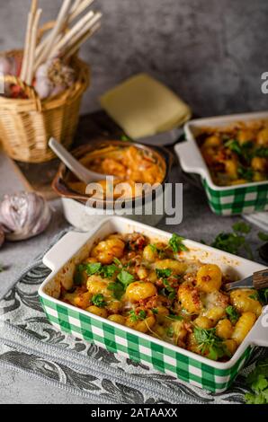 Super fast and delicious food, gratinated gnocchi with minced meat, tomatoes and cheese Stock Photo