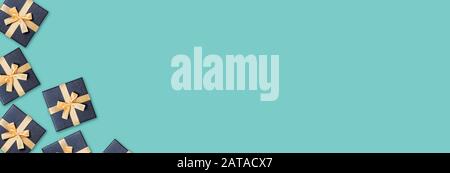 Celebration web-banner. Grey gift boxes with gold bow on green background. Flat lay, top view, copy space. Stock Photo