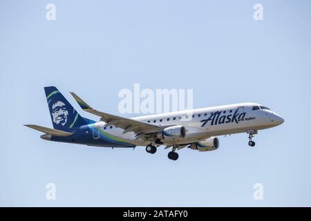 Portland, Oregon / USA - circa 2019: SkyWest Airlines Embraer ERJ-175 operating flights for Alaska Airlines landing at Portland International Airport Stock Photo