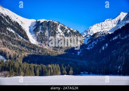 Terminal part of the lake at the bottom of the Anterselva valley communicating with Austria via the Stalle pass closed in winter Stock Photo