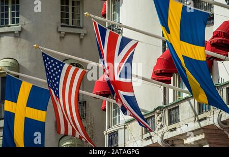 Flags of Great Britain, USA and Sweden on the facade of the hotel Stock Photo