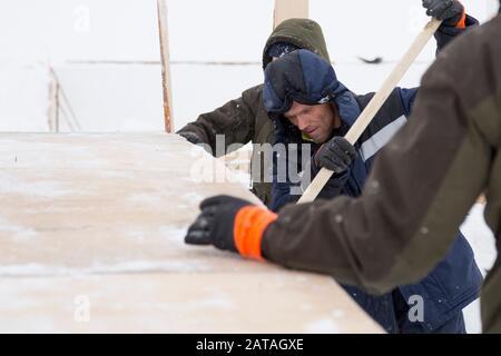Two workers in overalls at a construction site Stock Photo