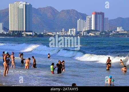 People enjoy the sea and beach at the seaside resort of  Nha Trang in Vietnam, South East Asia, Indochina, Asia, on a hot, sunny day. Stock Photo
