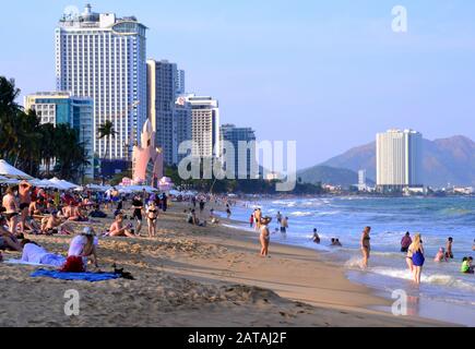 People enjoy the sea and beach at the seaside resort of  Nha Trang in Vietnam, South East Asia, Indochina, Asia, on a hot, sunny day. Stock Photo
