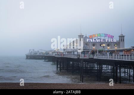 Palace Pier Brighton in the evening sea mist Stock Photo