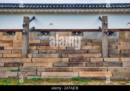 The stone defensive dobei  wall  with support posts behind them to increase their strength and loopholes for firing arrows or guns Ichi-tamon-yagura T Stock Photo