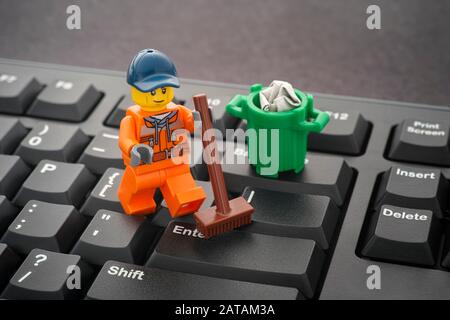 Tambov, Russian Federation - January 24, 2020 Lego minifigure cleaning keyboard with a broom. Stock Photo