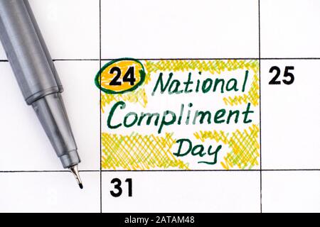 Reminder National Compliment Day in calendar with pen. January 24. Stock Photo