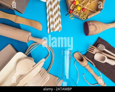 Zero waste concept. Textile brown eco bag, glass bottle, bamboo cutlery and kitchen utensils on blue background with Zero Waste concept. Eco friendly Stock Photo