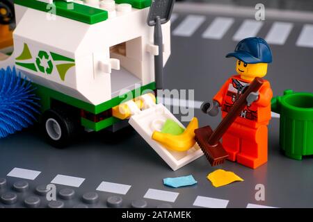 Tambov, Russian Federation - January 17, 2020 Lego cleaner with brush cleaning street and putting garbage in street sweeper truck. Studio shot. Stock Photo