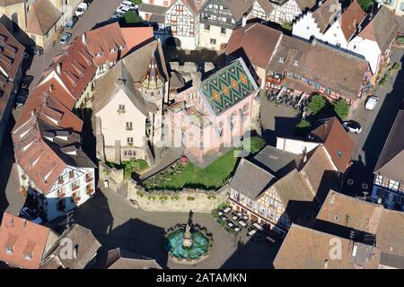AERIAL VIEW. Castle of Saint-Léon-Pfalz and traditional half-timbered homes. Eguisheim, Haut-Rhin, Alsace, Grand Est, France. Stock Photo