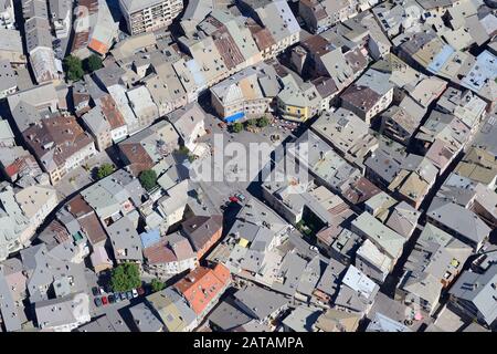 AERIAL VIEW. Barthelon Plaza in the historic center of the city of Embrun. Hautes-Alpes, France. Stock Photo