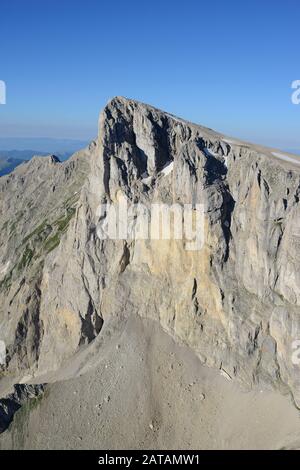 AERIAL VIEW. The massive eastern 600-meter-high rock face of Pic de Bure. Dévoluy Massif, Hautes-Alpes, France. Stock Photo