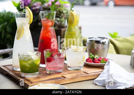 Summer soft drinks, a set of lemonades. Lemonades in jugs on the table, the ingredients of which they are made are arranged around Stock Photo