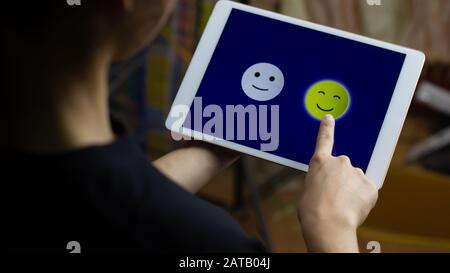 Conceptual the customer responded to the survey. The client choose a happy face smile icon on screen. Depicts that customer is very satisfied. Service Stock Photo