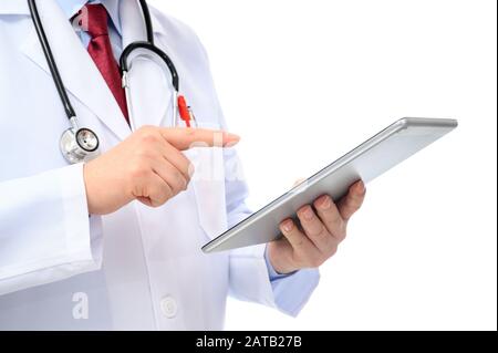 A side view of a male doctor using a tablet on a white background Stock Photo