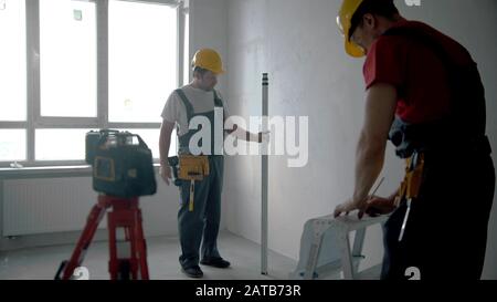 Repairing on an apartment - two men workers working indoors Stock Photo