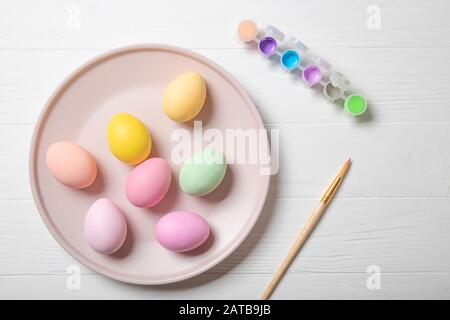 Multi-colored Easter eggs and paint brush. Stock Photo