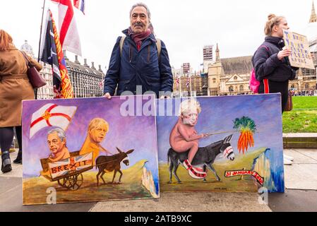 Kaya Mar artist on Brexit Day, 31 January 2020, in London, UK with satirical artworks featuring Boris Johnson and Nigel Farage cartoon style
