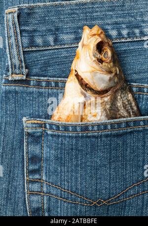 Blue jeans pocket with dried fish Stock Photo