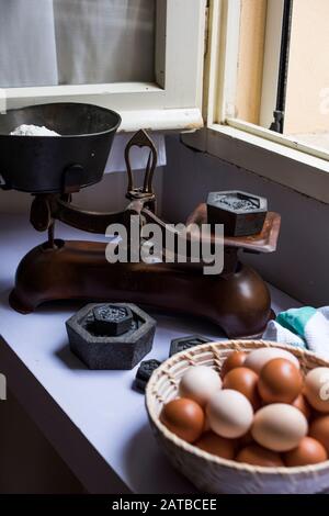 Flour being weighted on vintage scale Stock Photo