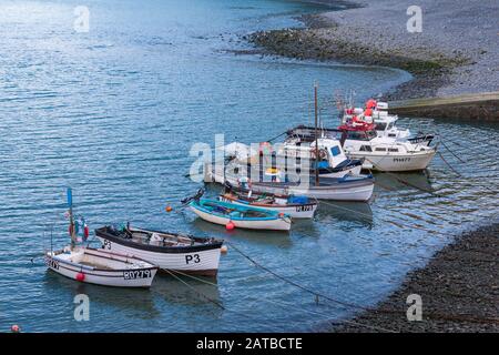 Boats moored at Clovelly harbour in north Devon on a calm sunny morning Stock Photo