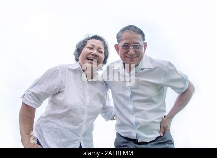 couple asian grandmother and grandmather smile from bottom view in happy emotion act on white background Stock Photo