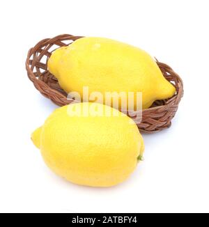 Two lemon fruit on bamboo bucket on white Stock Photo