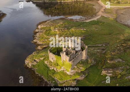 Aerial drone shot of Castle Tioram, it is a ruined castle that sits on the tidal island Eilean Tioram in Loch Moidart, Lochaber, Highland, Scotland. I Stock Photo