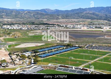 IRVINE, CALIFORNIA - 31 JAN 2020: Aerial view of the Tennis Facility, Soccer Fields with new homes and the santa Ana Mountains in the distance. Stock Photo