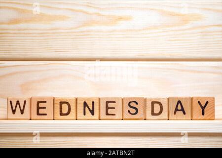 Wednesday written on toy cubes. Middle of working week. Day of the week. Wednesday made from vintage wooden cubes. Working day. Business concepts. Small business concept. Part of series Stock Photo