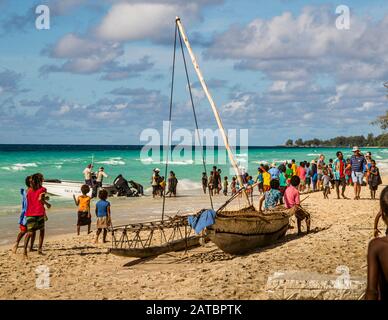 Local people and tourists are meeting on a beach in Papua New Guinea Stock Photo
