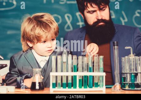 teacher man with little boy. Biology Science lab. father and son at school. learning chemistry in school laboratory. Back to school. Scientist research and experiments. I zinc I like you. Stock Photo
