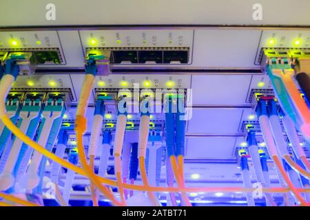 High-speed Internet connection to the master server is in a modern data center.  Many optical links are on the front panel of the main router. Stock Photo