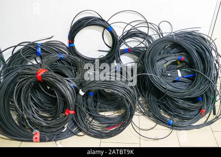 Heap of coiled wires close-up. Powerful trunk cables wound in a circle Stock Photo